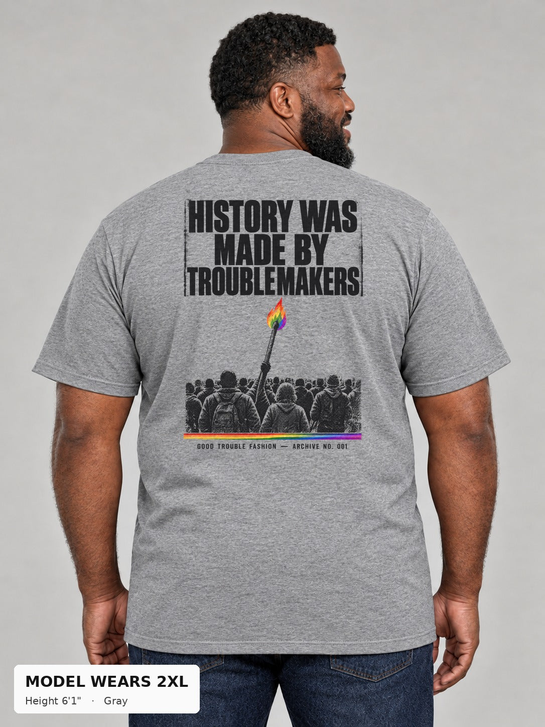 Good Trouble Archive 001 Tee in Gray, back view showing the HISTORY WAS MADE BY TROUBLEMAKERS poster back print, on a plus-size model wearing size 2XL, 6'1" - Good Trouble Fashion