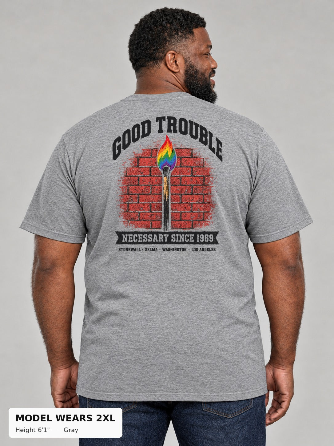 Good Trouble Necessary Since 1969 Tee in Gray, back view showing the GOOD TROUBLE brick-wall match back print, on a plus-size model wearing size 2XL, 6'1" - Good Trouble Fashion