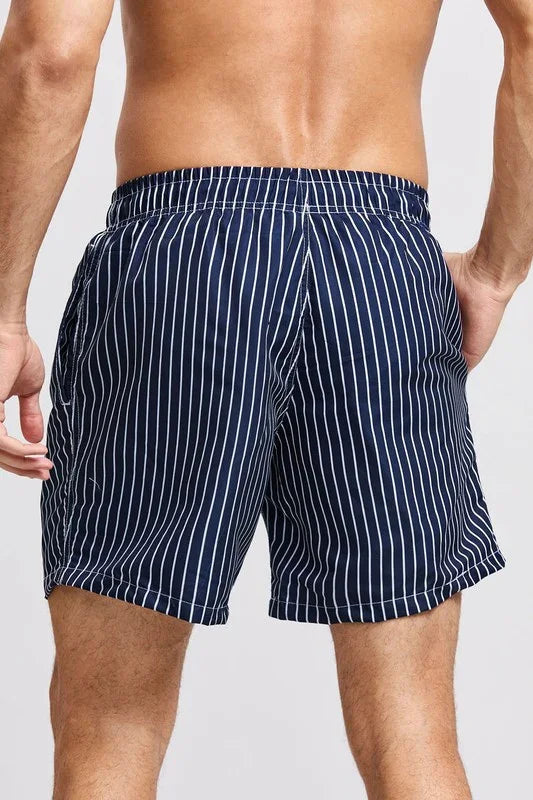 Good Trouble Garments men's striped swim shorts in navy blue with white vertical stripes