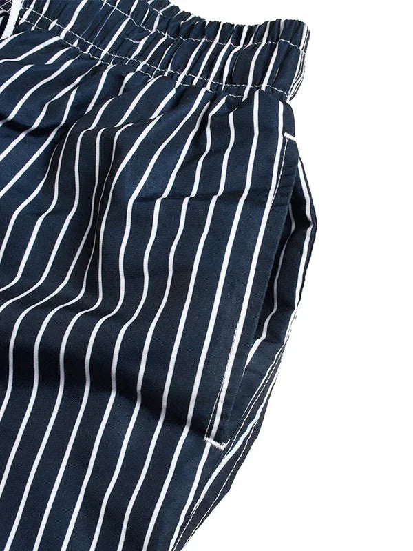Good Trouble Garments men's striped swim shorts in navy blue with white vertical stripes and elastic waistband