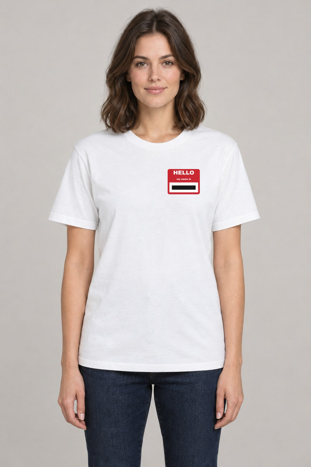 Redacted Name Tag Epstein Files Tee in White, front view showing the redacted name tag left-chest badge, on a slim model wearing size S, 5'8" - Good Trouble Fashion