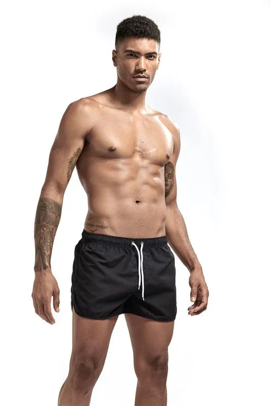 Good Trouble Garments short swim shorts with drawstring worn by male model in black