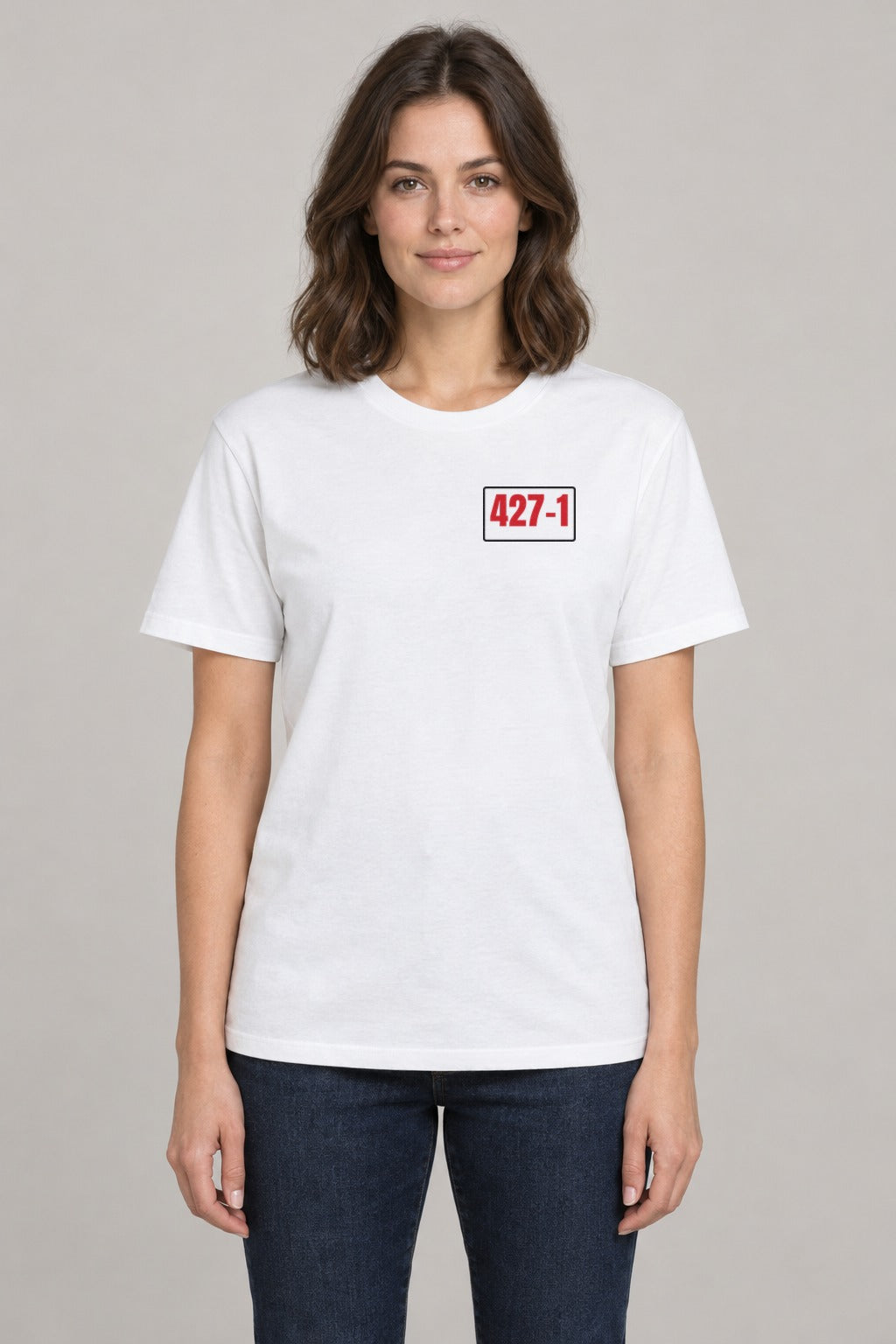 427–1 Release the Epstein Files Tee in White, front view showing the 427–1 left-chest badge, on a slim model wearing size S, 5'8" - Good Trouble Fashion