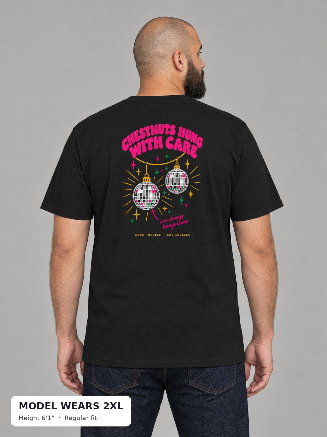 Chestnuts Hung With Care Tee in Black, back view, on a plus-size model wearing size 2XL, 6'1" - Good Trouble Fashion