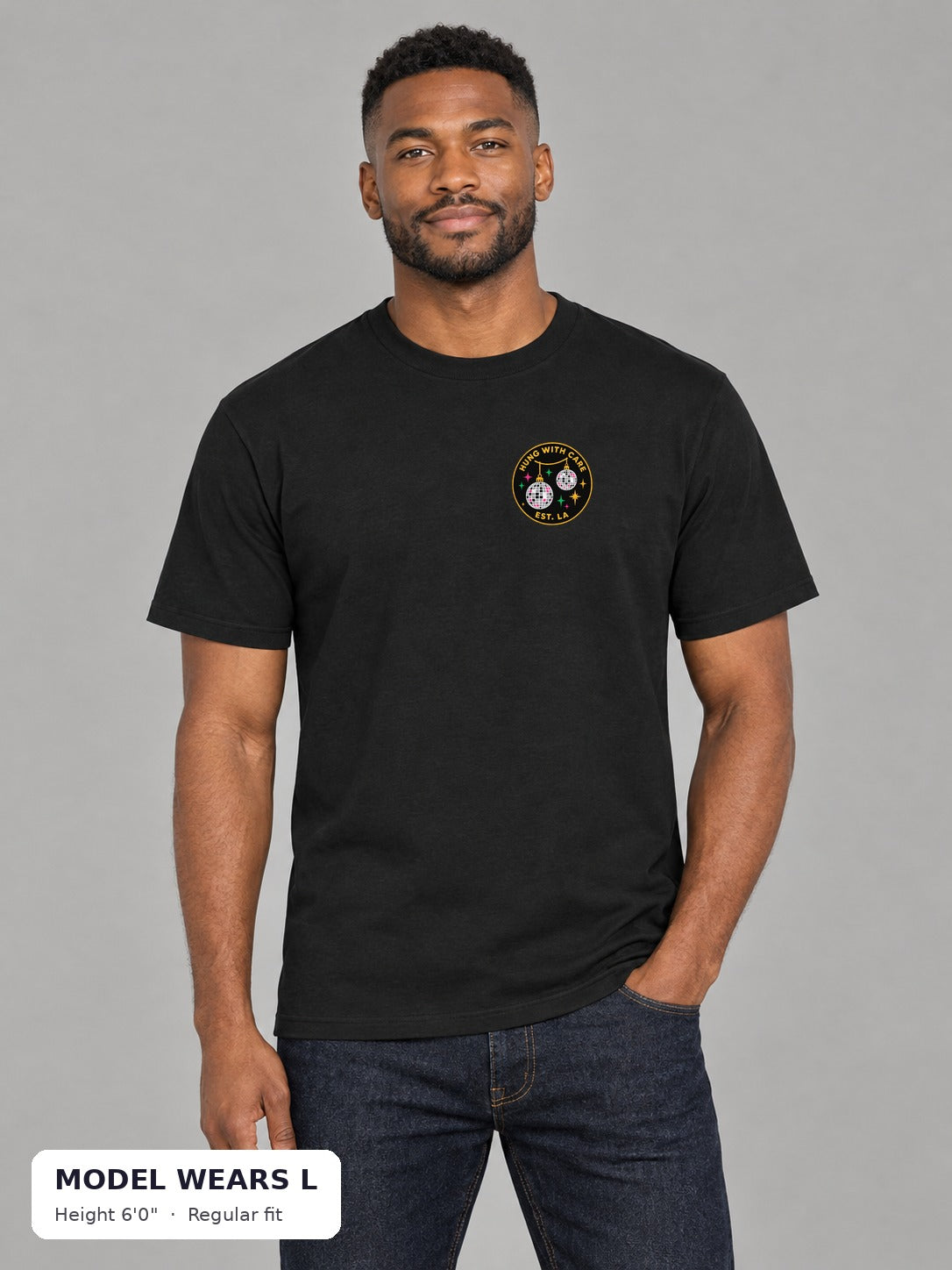 Chestnuts Hung With Care Tee in Black, front view with left-chest badge, on an athletic model wearing size L, 6'0" - Good Trouble Fashion