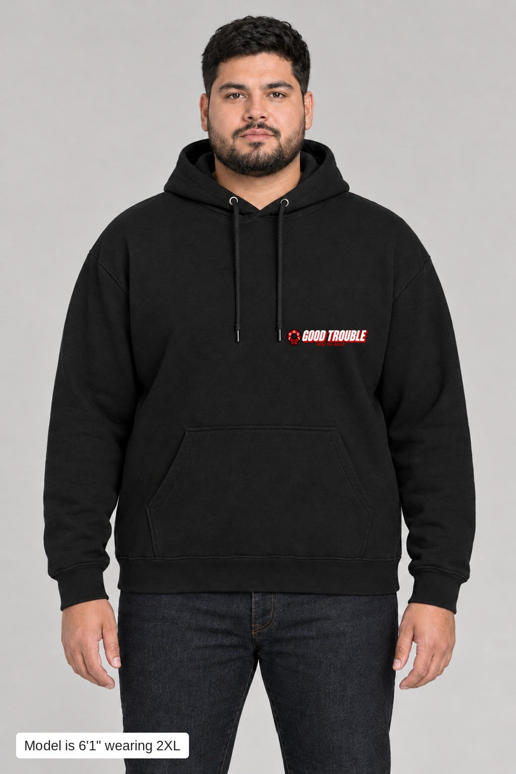 Deck the Halls Hoodie in Black, front view with Good Trouble chest logo, model is 6'1" wearing 2XL