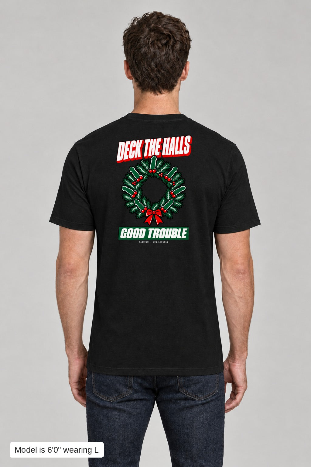 Deck the Halls Tee in Black, back view with Street Bold wreath print, model is 6'0" wearing L