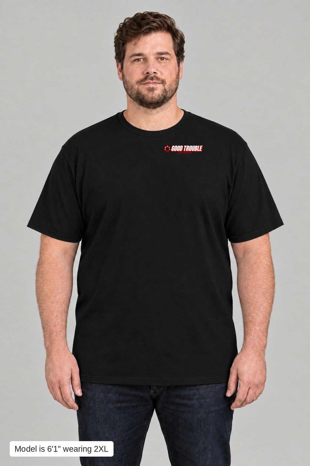 Deck the Halls Tee in Black, front view with Good Trouble chest logo, model is 6'1" wearing 2XL