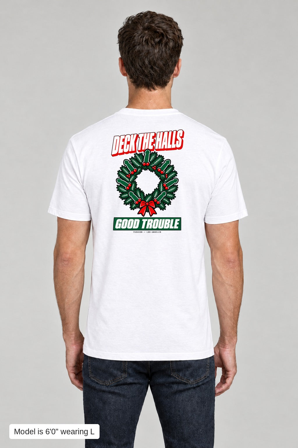 Deck the Halls Tee in White, back view with Street Bold wreath print, model is 6'0" wearing L