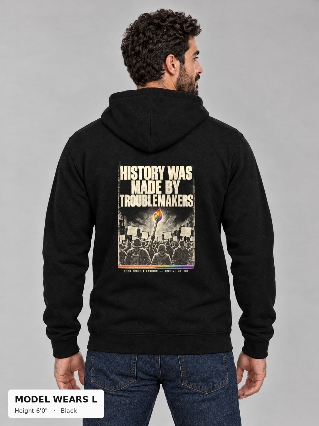 Good Trouble Archive 001 Hoodie in Black, back view showing the HISTORY WAS MADE BY TROUBLEMAKERS poster back print, on an athletic model wearing size L, 6'0" - Good Trouble Fashion