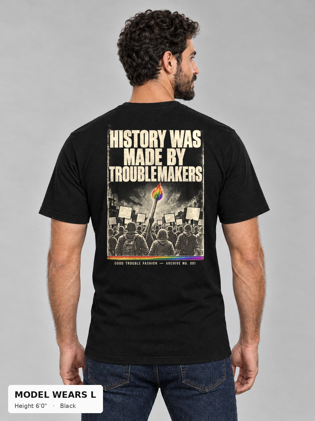 Good Trouble Archive 001 Tee in Black, back view showing the HISTORY WAS MADE BY TROUBLEMAKERS poster back print, on an athletic model wearing size L, 6'0" - Good Trouble Fashion