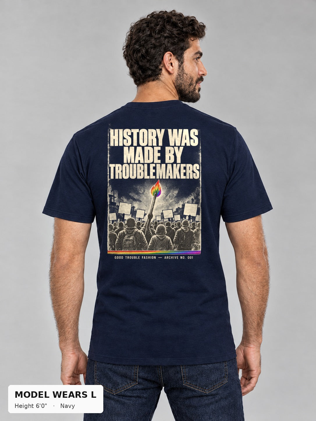 Good Trouble Archive 001 Tee in Navy, back view showing the HISTORY WAS MADE BY TROUBLEMAKERS poster back print, on an athletic model wearing size L, 6'0" - Good Trouble Fashion