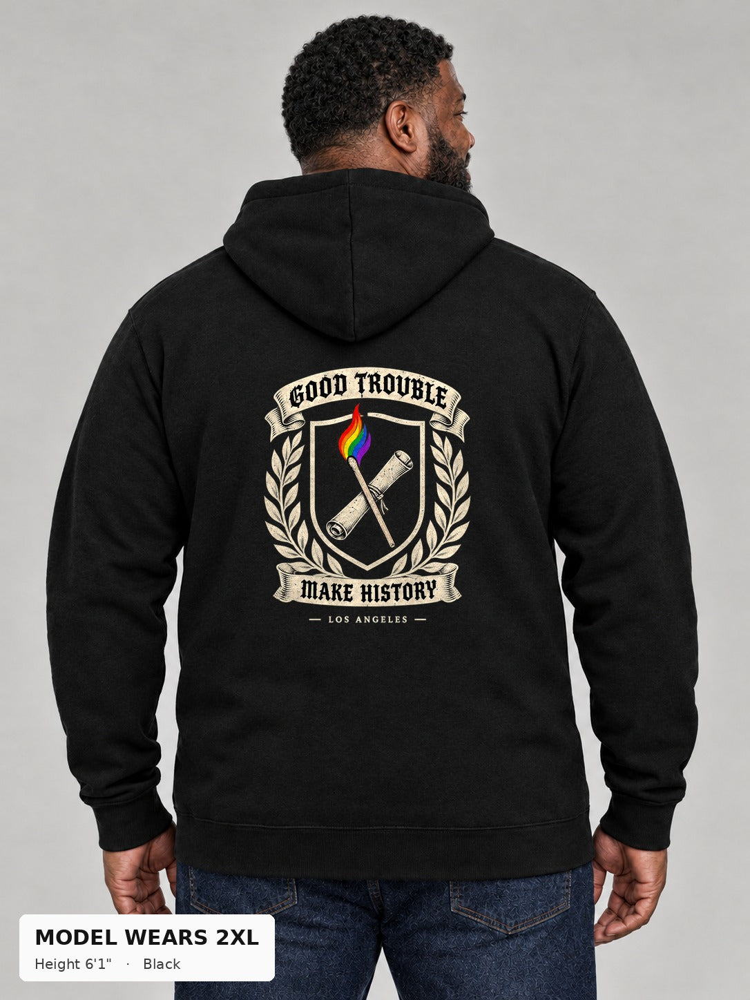 Good Trouble Heritage Crest Hoodie in Black, back view showing the GOOD TROUBLE Make History crest back print, on a plus-size model wearing size 2XL, 6'1" - Good Trouble Fashion