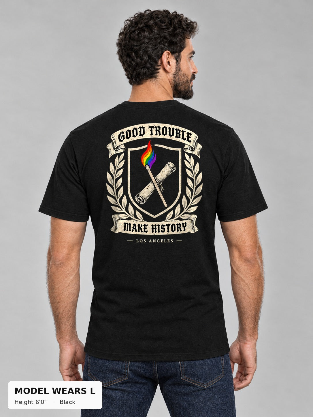 Good Trouble Heritage Crest Tee in Black, back view showing the GOOD TROUBLE Make History crest back print, on an athletic model wearing size L, 6'0" - Good Trouble Fashion