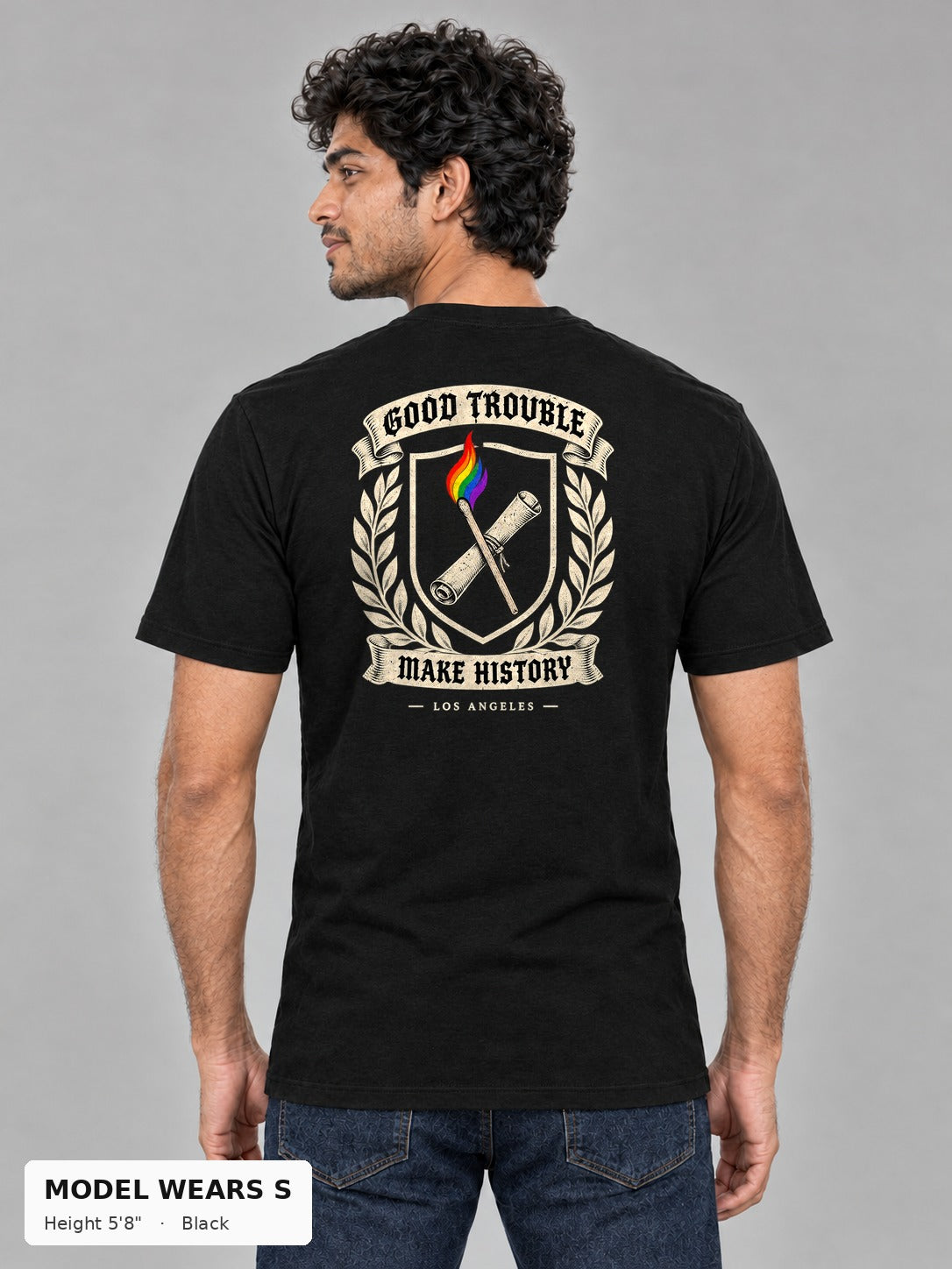 Good Trouble Heritage Crest Tee in Black, back view showing the GOOD TROUBLE Make History crest back print, on a slim model wearing size S, 5'8" - Good Trouble Fashion