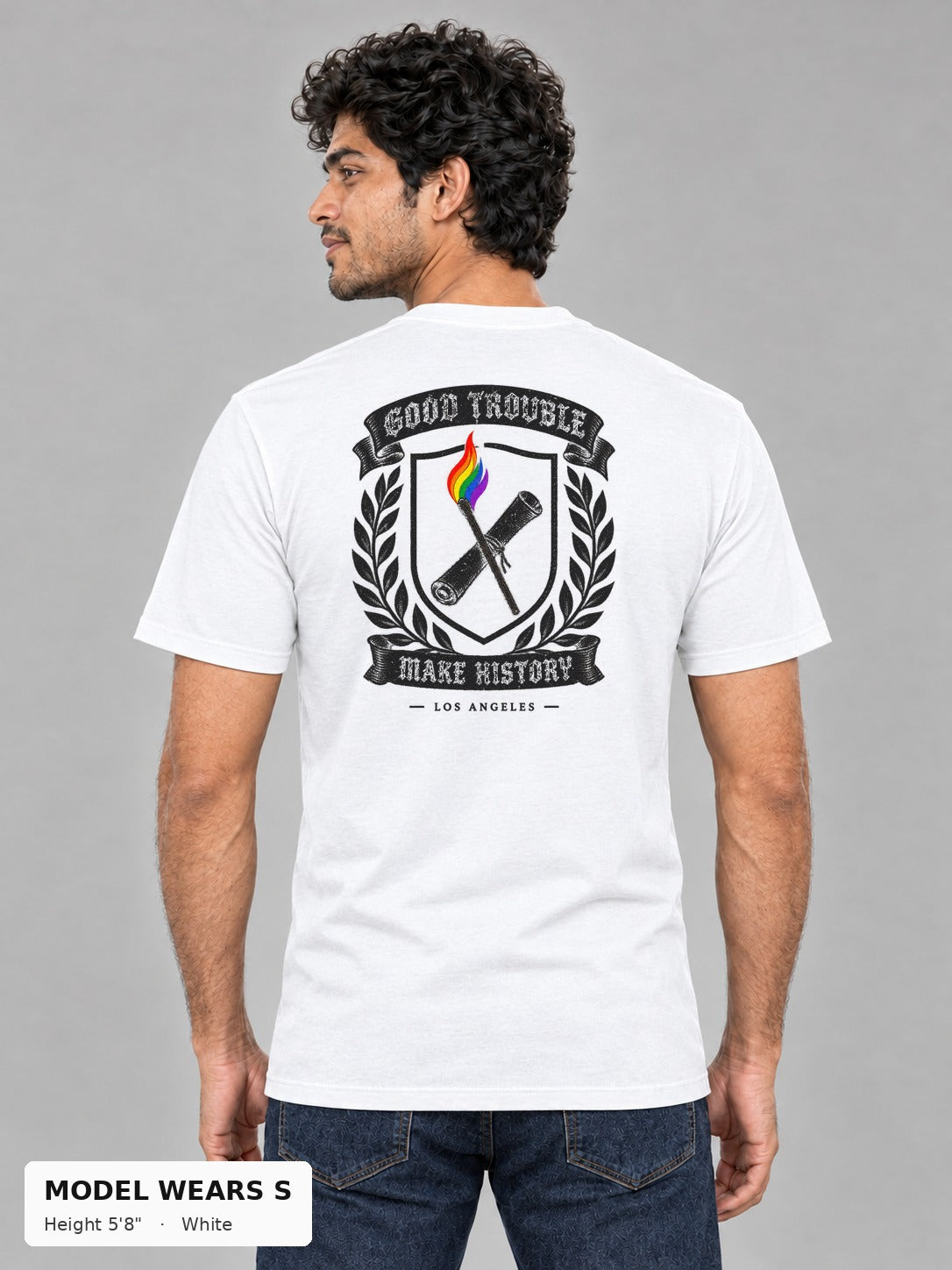 Good Trouble Heritage Crest Tee in White, back view showing the GOOD TROUBLE Make History crest back print, on a slim model wearing size S, 5'8" - Good Trouble Fashion