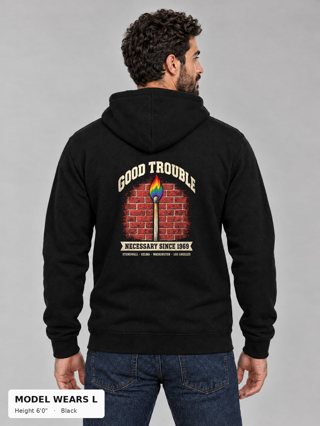 Good Trouble Necessary Since 1969 Hoodie in Black, back view showing the GOOD TROUBLE brick-wall match back print, on an athletic model wearing size L, 6'0" - Good Trouble Fashion