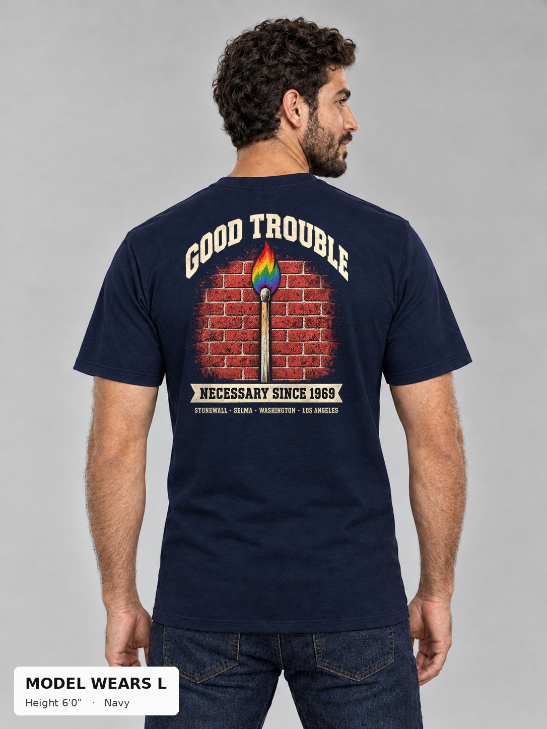 Good Trouble Necessary Since 1969 Tee in Navy, back view showing the GOOD TROUBLE brick-wall match back print, on an athletic model wearing size L, 6'0" - Good Trouble Fashion
