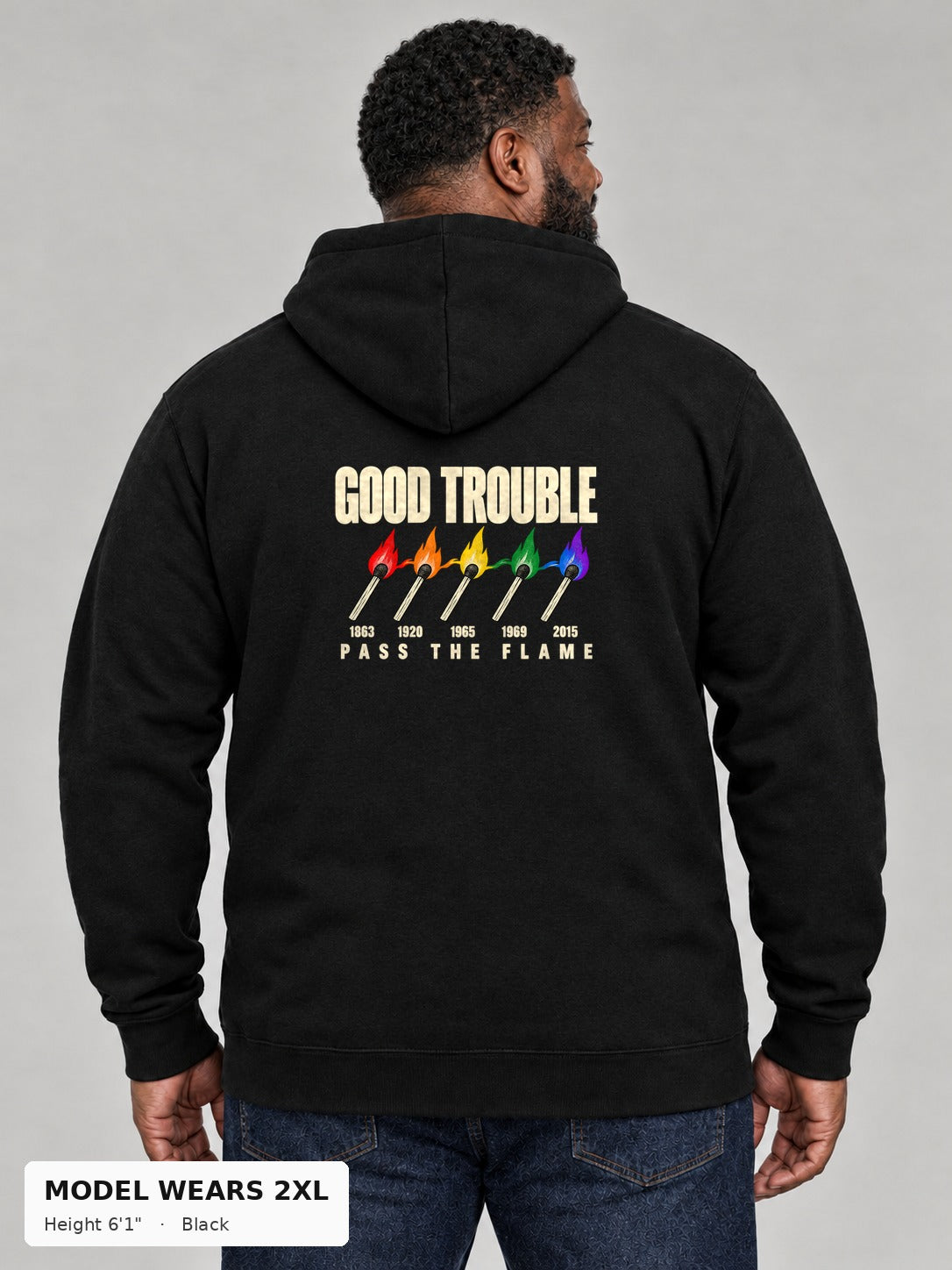 Good Trouble Pass the Flame Hoodie in Black, back view showing the PASS THE FLAME five-match back print, on a plus-size model wearing size 2XL, 6'1" - Good Trouble Fashion