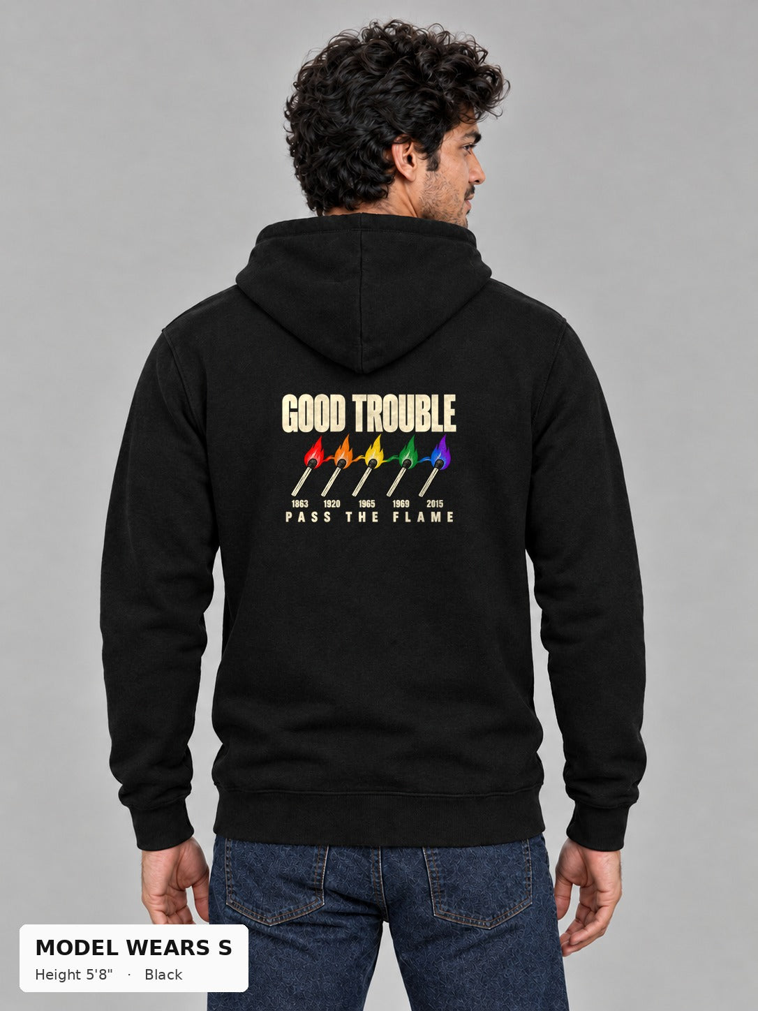 Good Trouble Pass the Flame Hoodie in Black, back view showing the PASS THE FLAME five-match back print, on a slim model wearing size S, 5'8" - Good Trouble Fashion