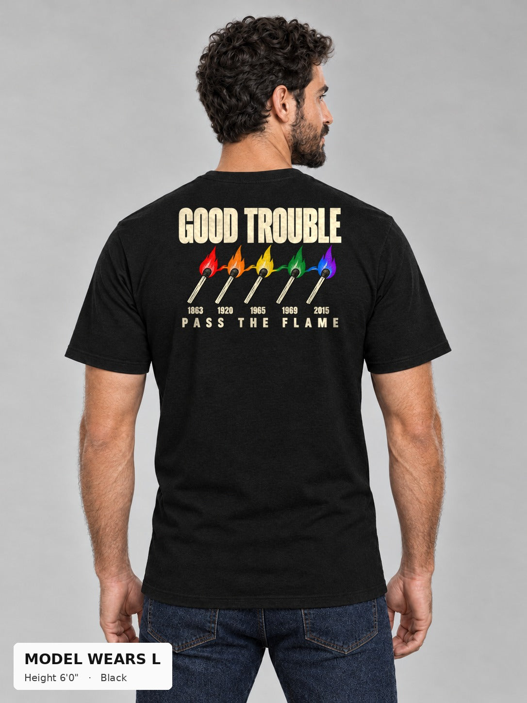 Good Trouble Pass the Flame Tee in Black, back view showing the PASS THE FLAME five-match back print, on an athletic model wearing size L, 6'0" - Good Trouble Fashion