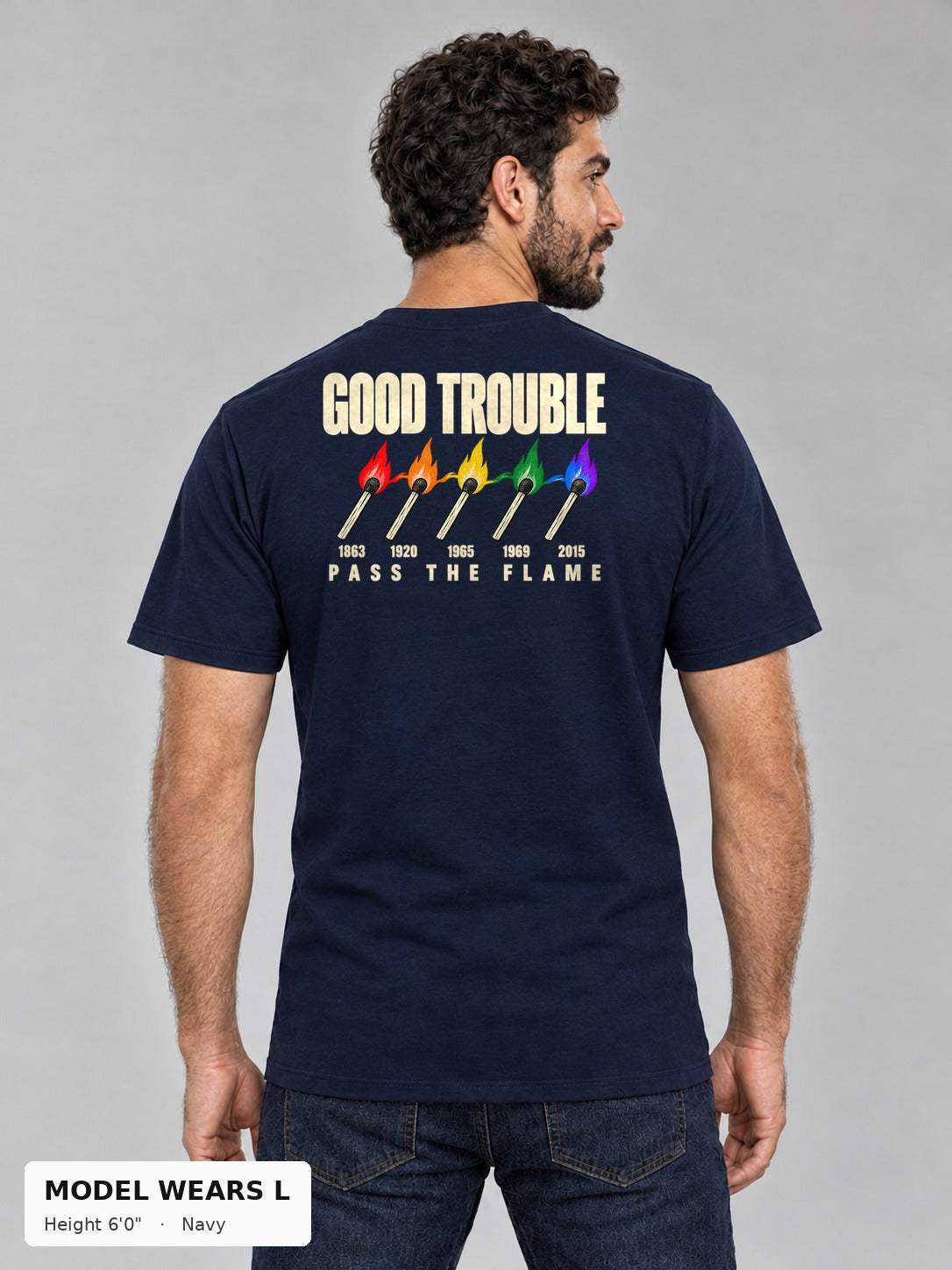 Good Trouble Pass the Flame Tee in Navy, back view showing the PASS THE FLAME five-match back print, on an athletic model wearing size L, 6'0" - Good Trouble Fashion
