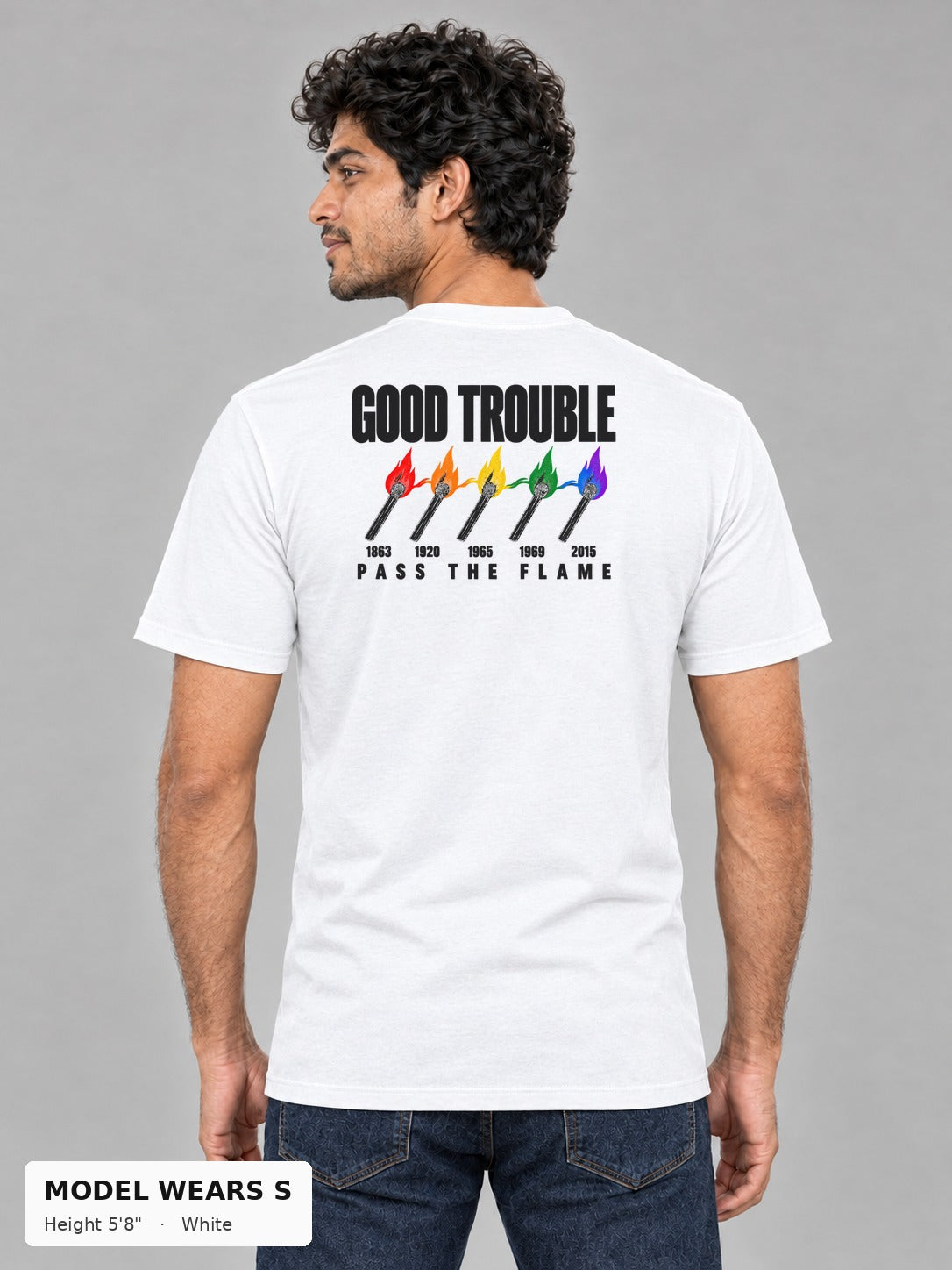 Good Trouble Pass the Flame Tee in White, back view showing the PASS THE FLAME five-match back print, on a slim model wearing size S, 5'8" - Good Trouble Fashion