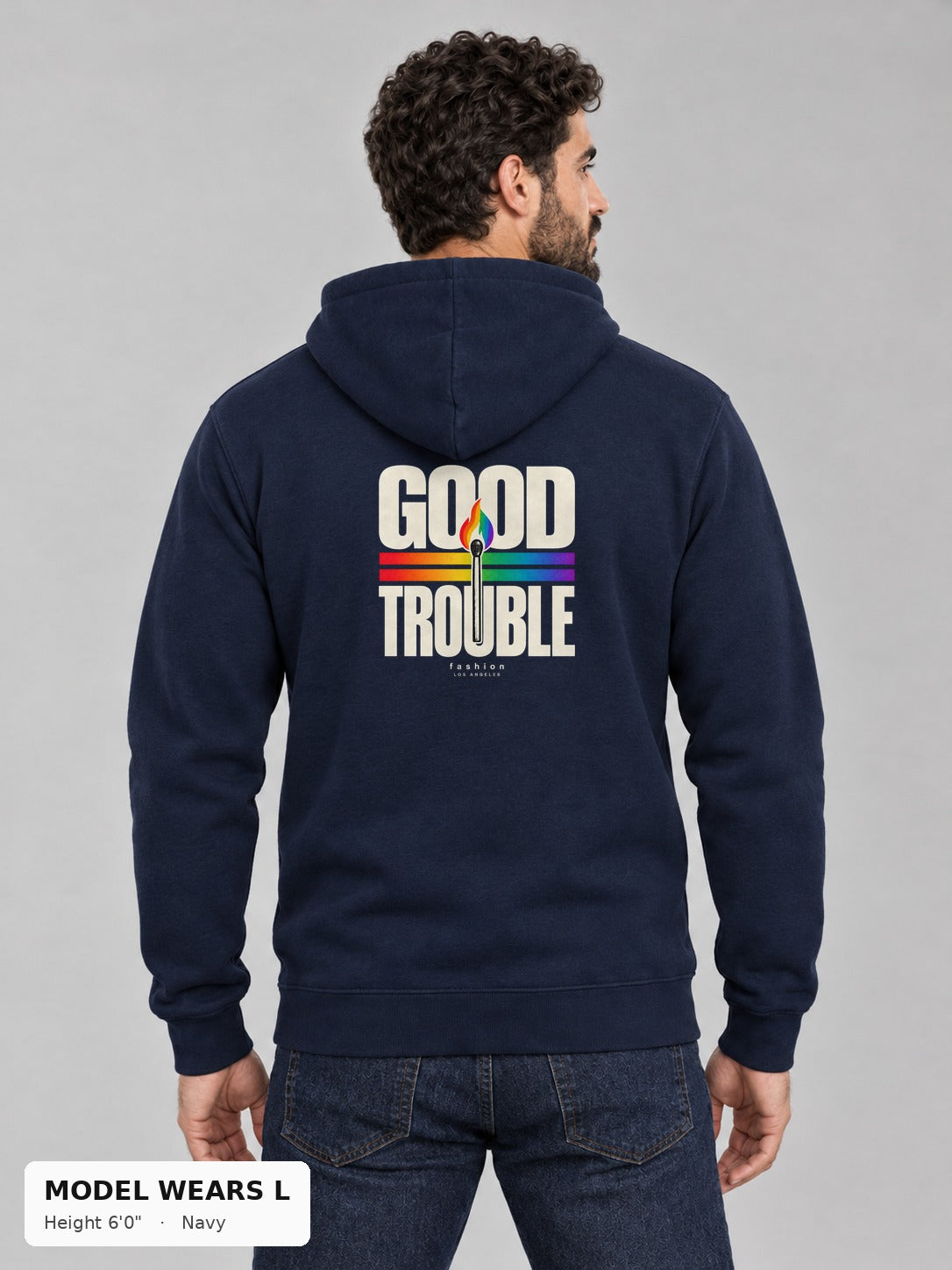 Good Trouble Spark Hoodie in Navy, back view showing the GOOD TROUBLE rainbow match back print, on an athletic model wearing size L, 6'0" - Good Trouble Fashion