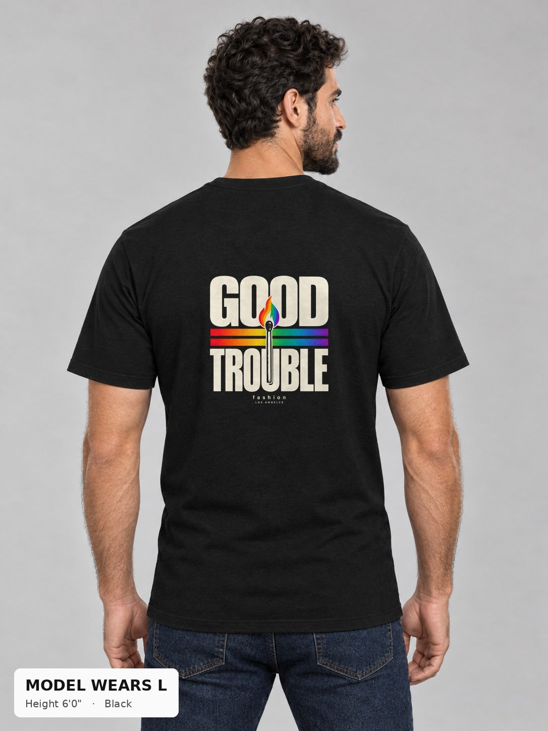 Good Trouble Spark Tee in Black, back view showing the GOOD TROUBLE rainbow match back print, on an athletic model wearing size L, 6'0" - Good Trouble Fashion