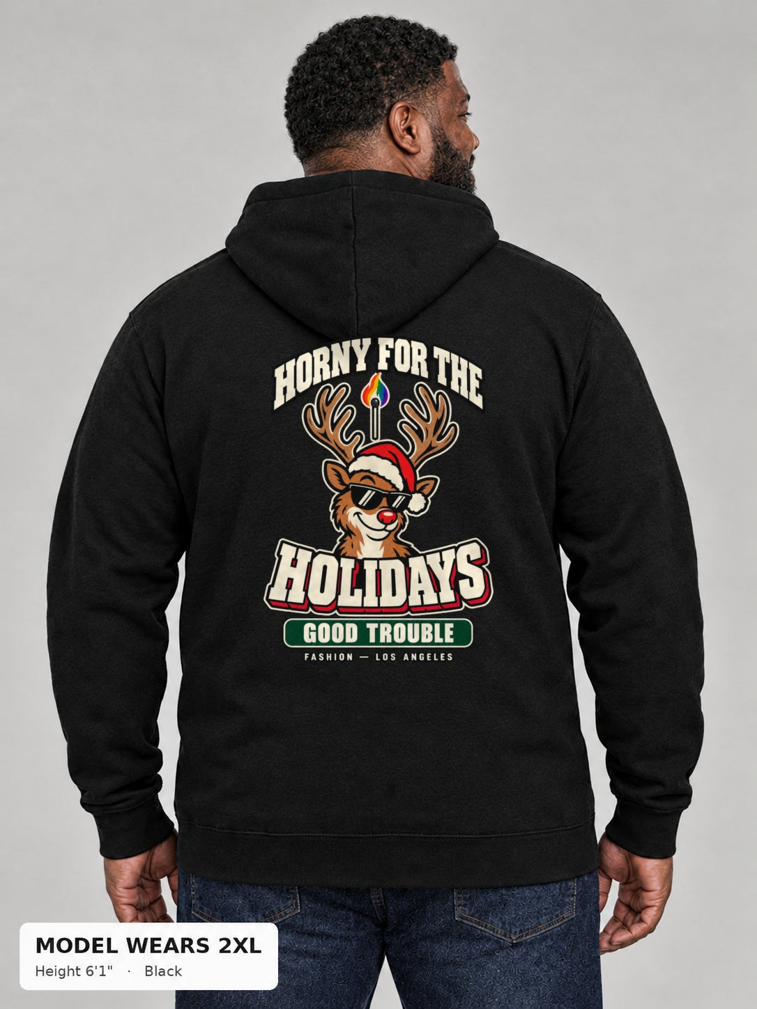 Horny for the Holidays Hoodie in Black, back view showing the HORNY FOR THE HOLIDAYS reindeer back print, on a plus-size model wearing size 2XL, 6'1" - Good Trouble Fashion