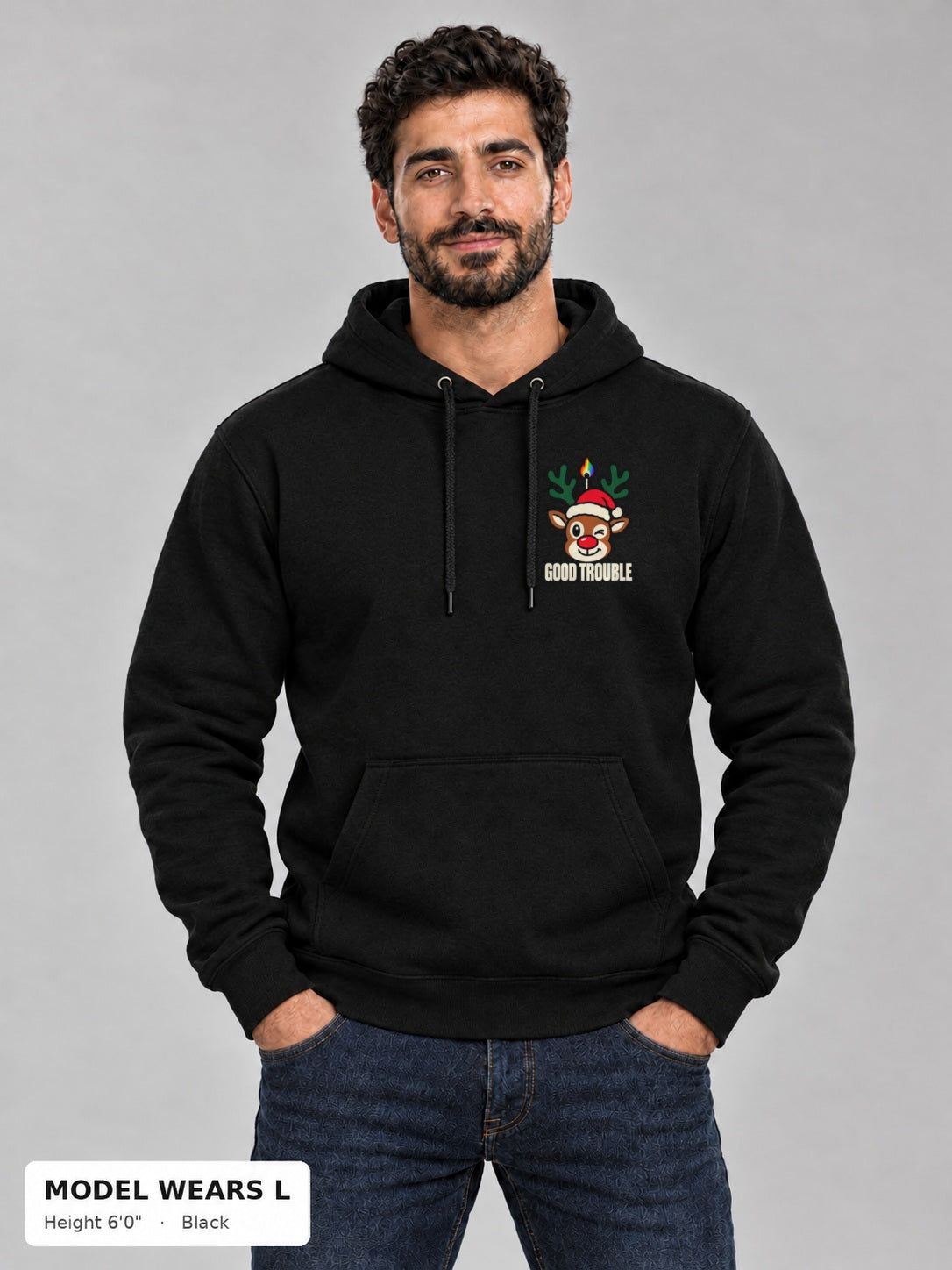 Horny for the Holidays Hoodie in Black, front view showing the left-chest winking reindeer logo, on an athletic model wearing size L, 6'0" - Good Trouble Fashion