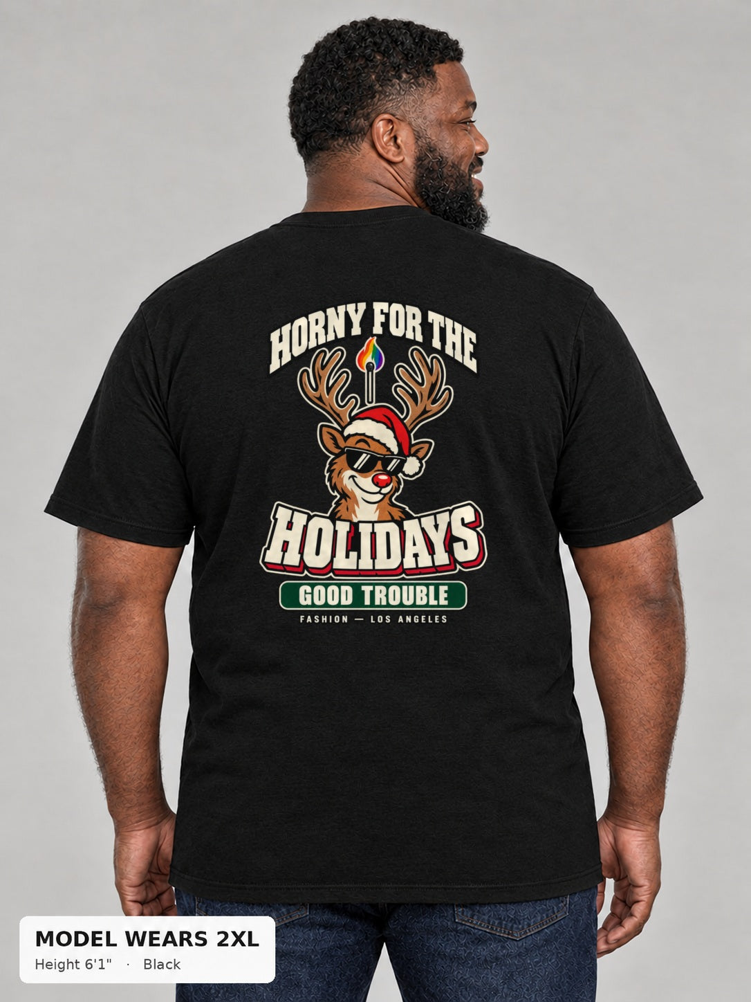 Horny for the Holidays Tee in Black, back view showing the HORNY FOR THE HOLIDAYS reindeer back print, on a plus-size model wearing size 2XL, 6'1" - Good Trouble Fashion