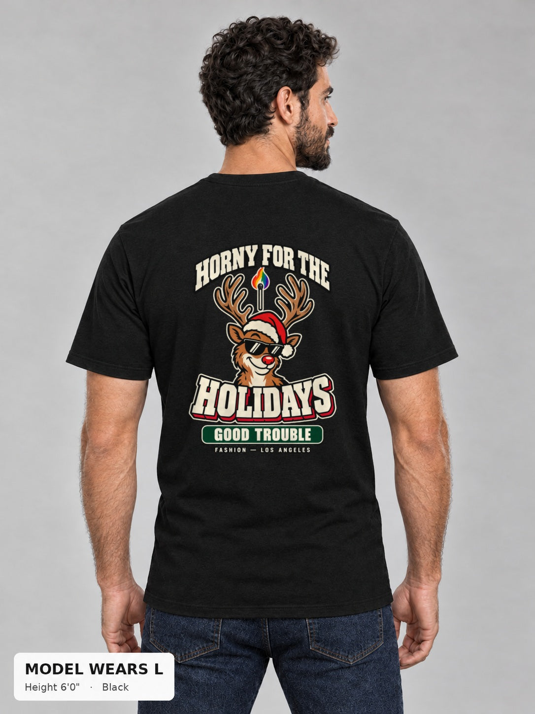 Horny for the Holidays Tee in Black, back view showing the HORNY FOR THE HOLIDAYS reindeer back print, on an athletic model wearing size L, 6'0" - Good Trouble Fashion