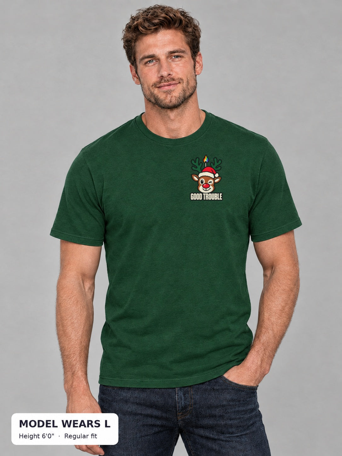 Horny for the Holidays Tee in Green, front view showing the left-chest winking reindeer logo, on an athletic model wearing size L, 6'0" - Good Trouble Fashion