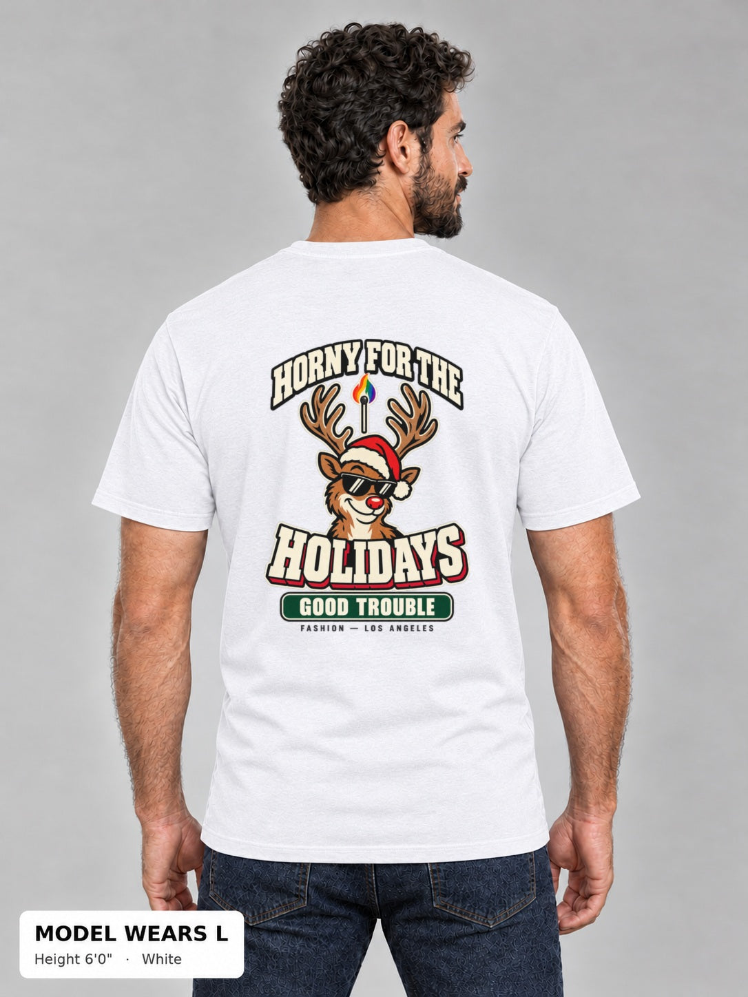 Horny for the Holidays Tee in White, back view showing the HORNY FOR THE HOLIDAYS reindeer back print, on an athletic model wearing size L, 6'0" - Good Trouble Fashion