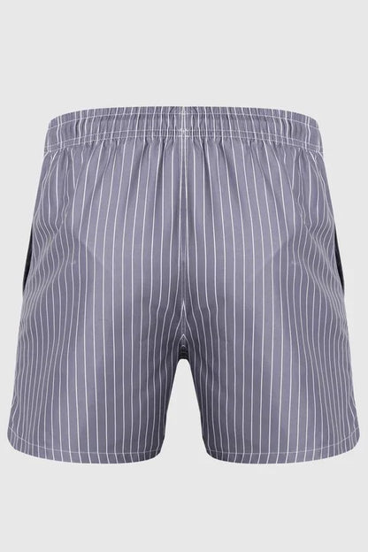 Good Trouble Garments men's striped swim shorts in gray with white vertical stripes and elastic waistband