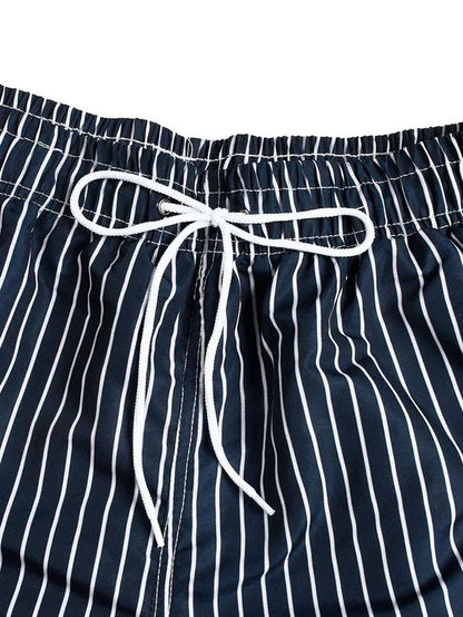 Good Trouble Garments men's striped swim shorts with navy blue and white vertical stripes and white drawstring