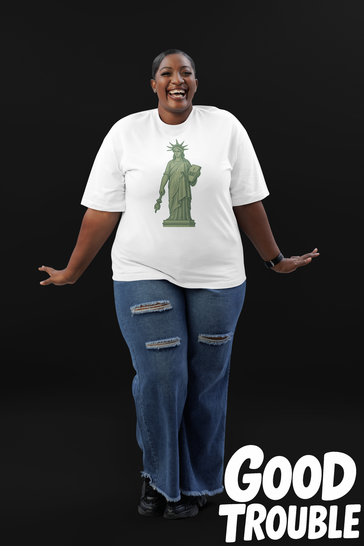 Smiling woman wearing a humorous Statue of Liberty shirt by Good Trouble Fashion with ripped jeans