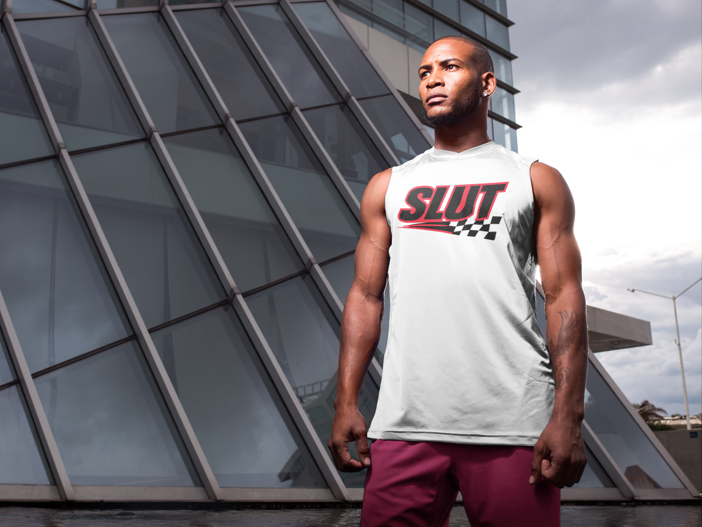 Man wearing a white slut racer t-shirt for men with bold red and black graphic print