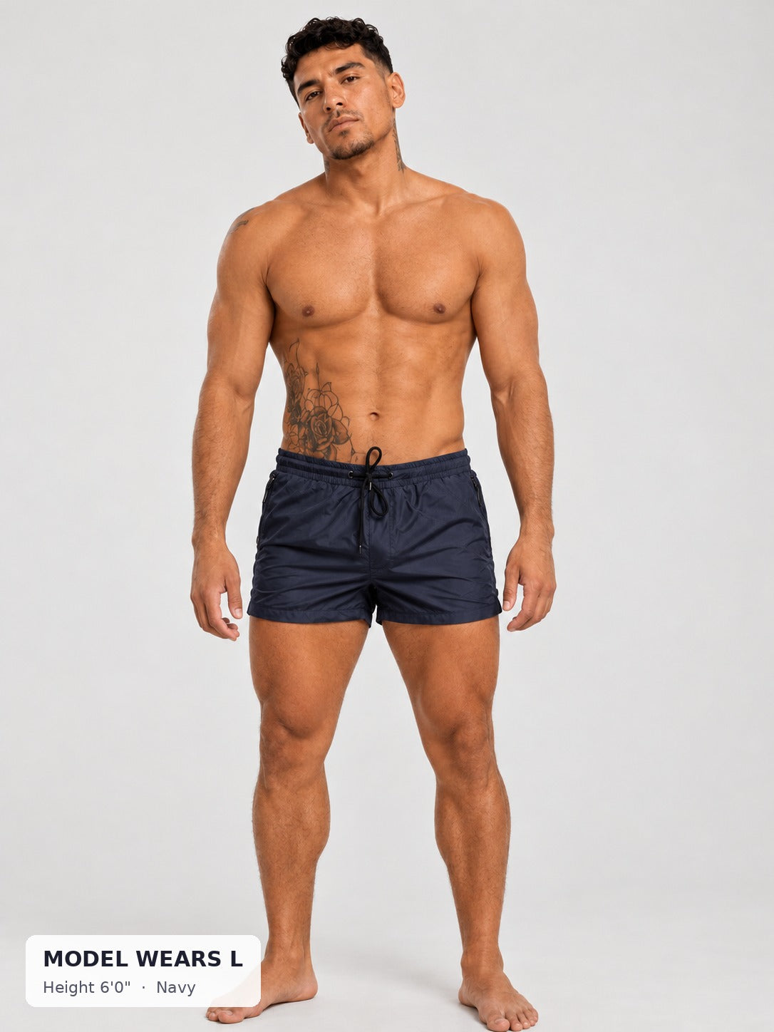 CODE 22 Solid Swim Trunks in Navy on an athletic model wearing size L, 6'0"