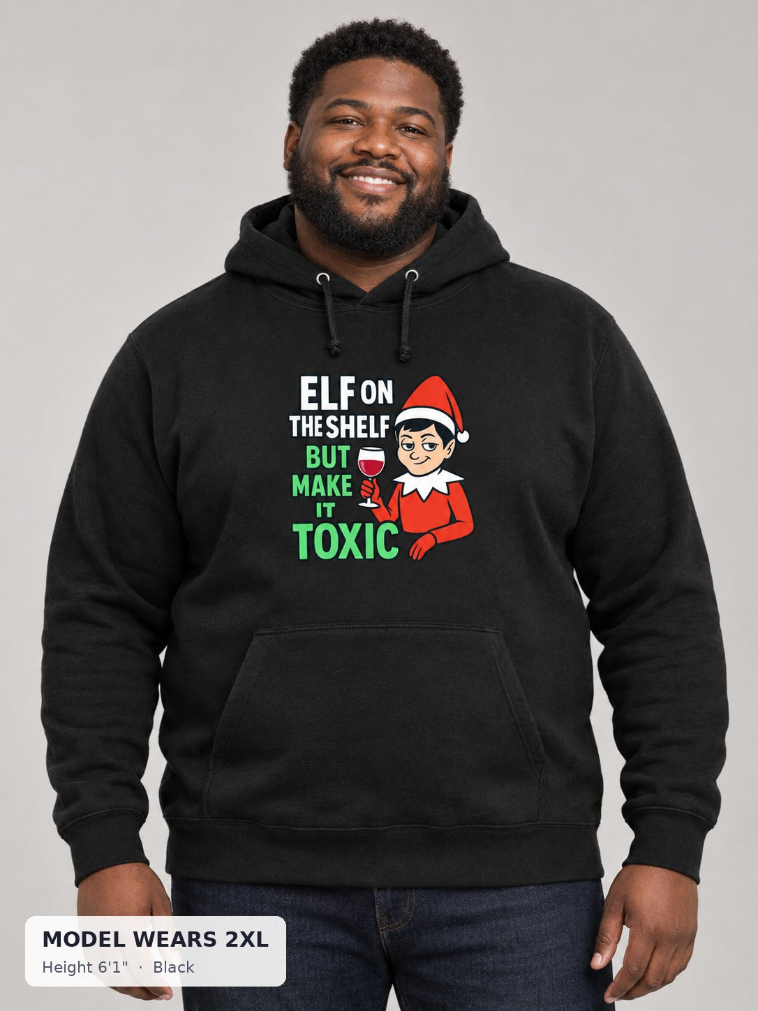 Toxic Elf on the Shelf Hoodie in Black on a plus-size model wearing size 2XL, 6'1" - Good Trouble Fashion