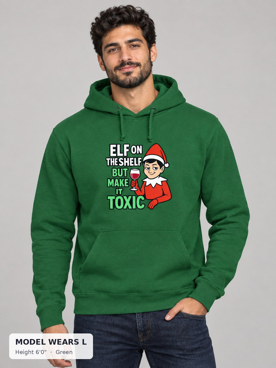 Toxic Elf on the Shelf Hoodie in Green on an athletic model wearing size L, 6'0" - Good Trouble Fashion