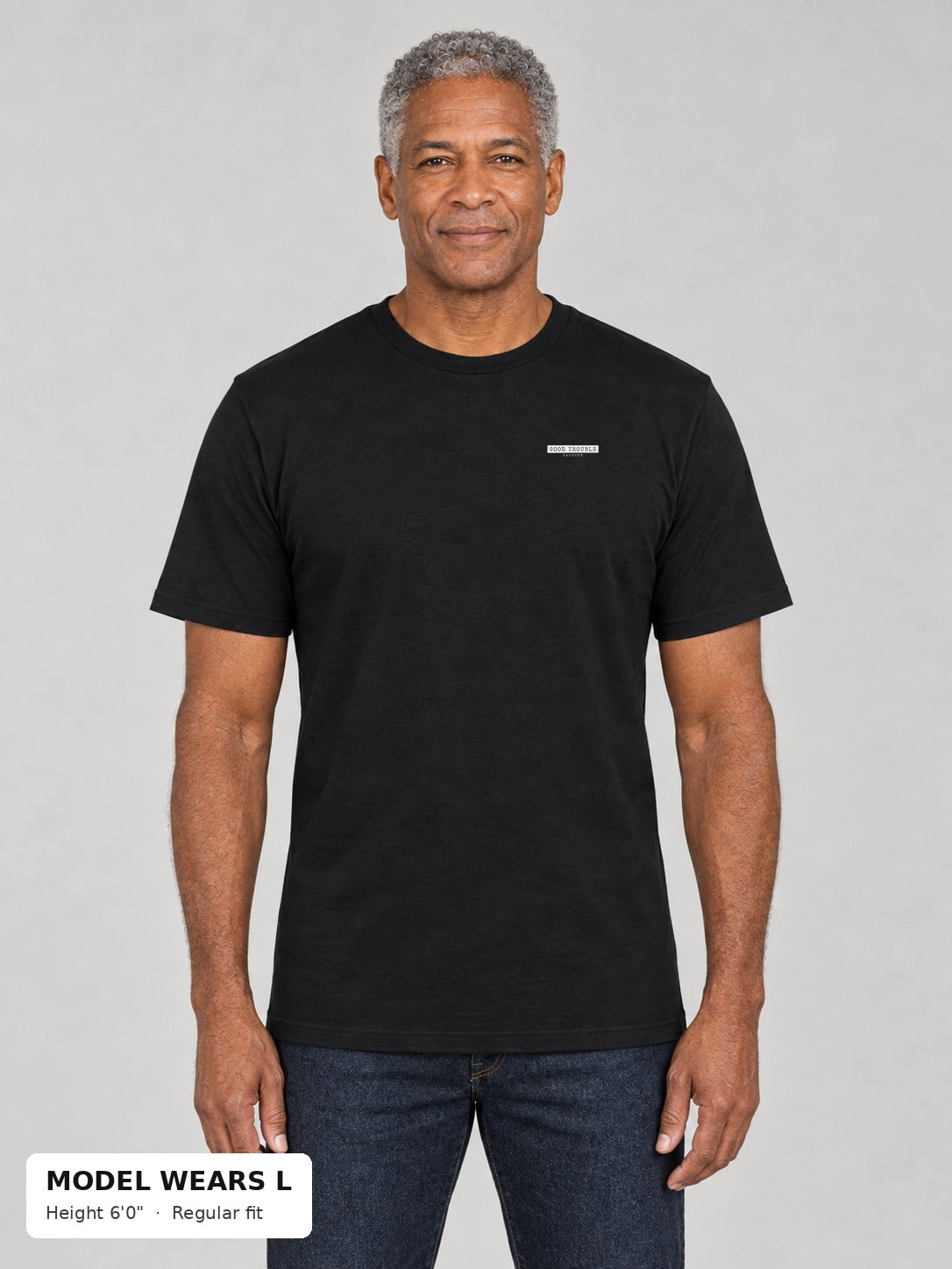 Unapologetic Pride Tee in Black, front, Good Trouble Fashion left-chest label, on an athletic model wearing size L, 6'0" - Good Trouble Fashion