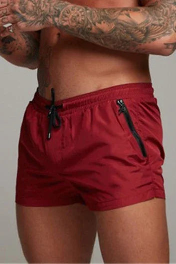 Good Trouble Garments short sexy swim trunks in red with zipper pocket and drawstring waist
